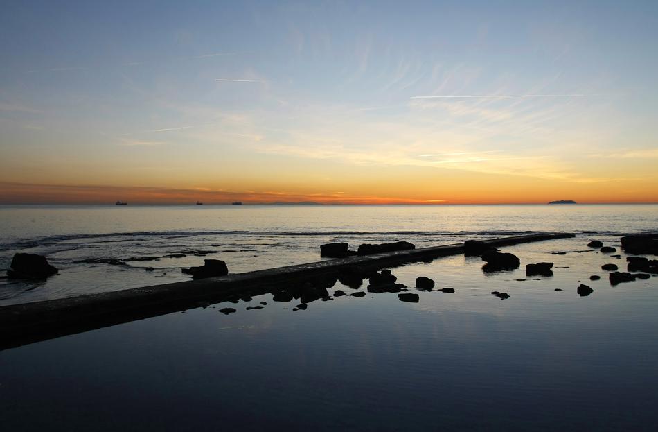 golden sky at horizon, Sunset afterglow over Sea