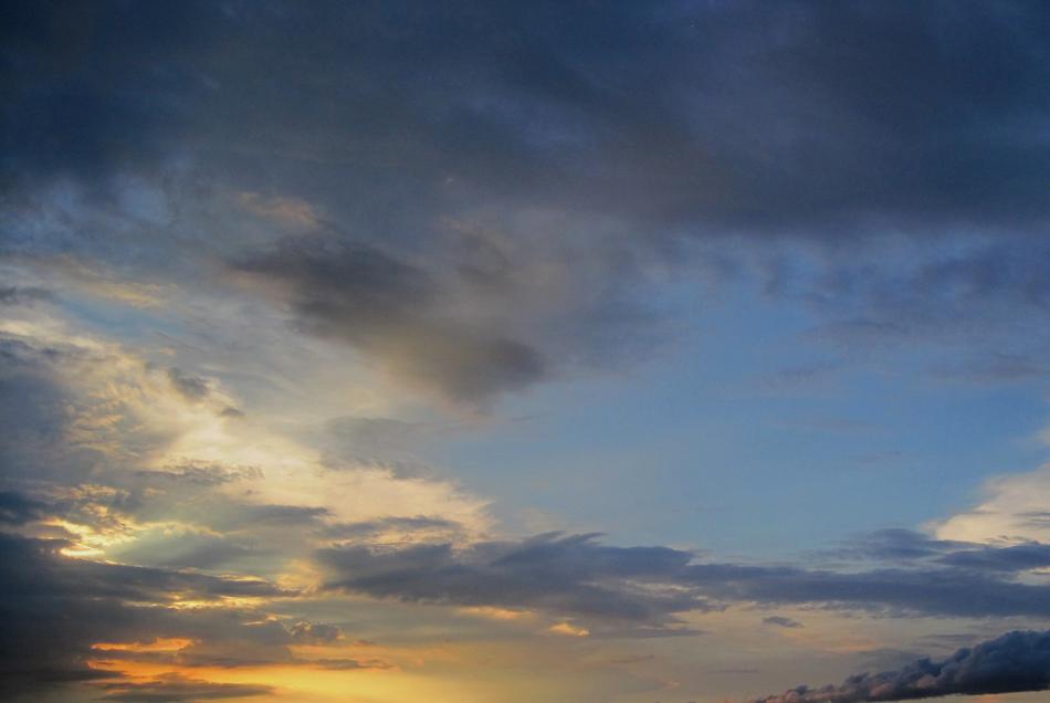 white, golden and dark Clouds in evening sky