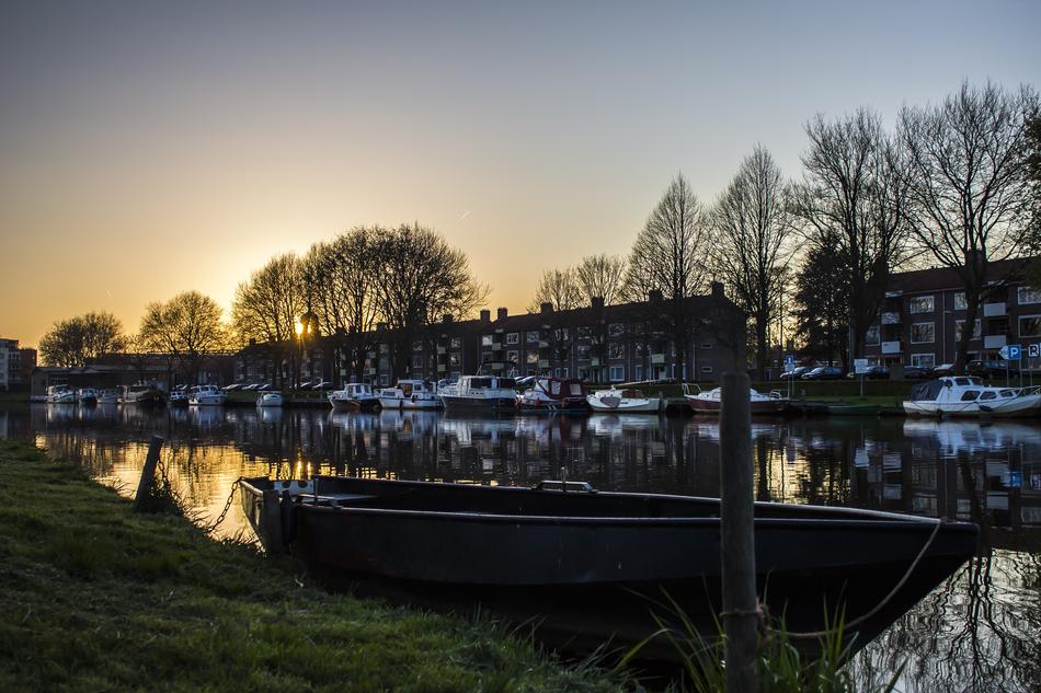 moored Boats near city waterfront at dusk, netherlands
