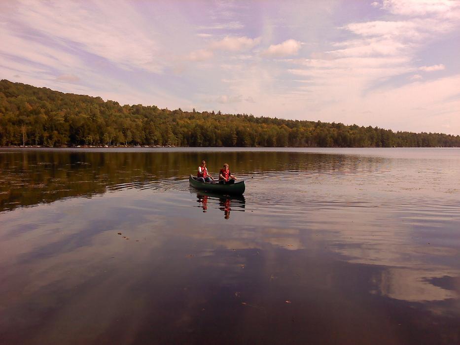 people relaxing on a boat in a lake