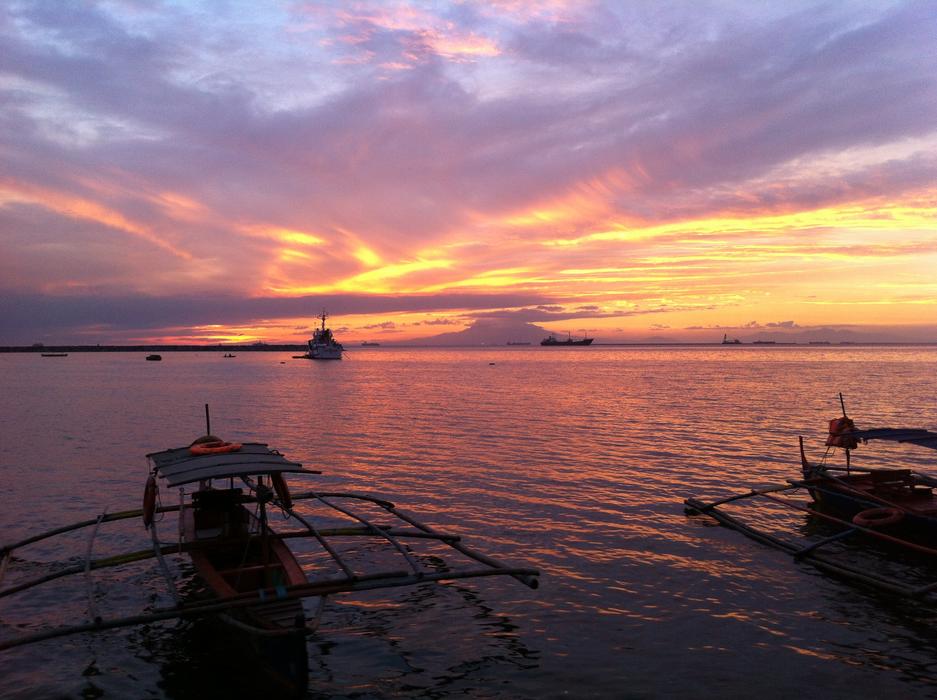 anchored traditional fishing boats at scenic sunset