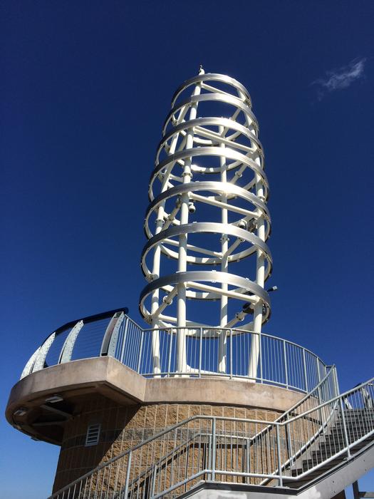 A large radio tower against a blue sky
