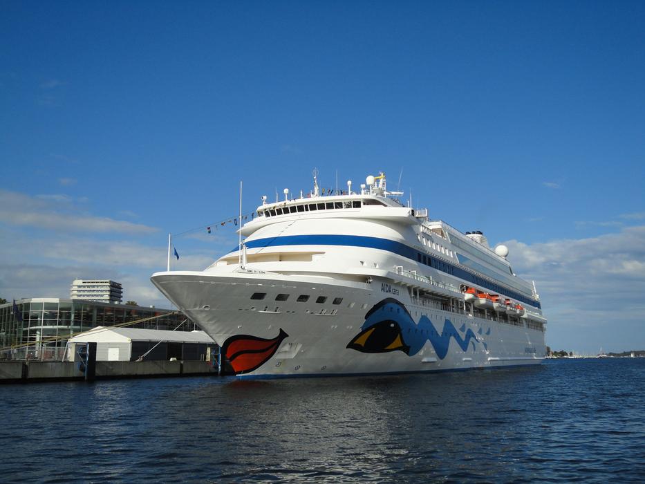 a huge resort ship in the ocean stands