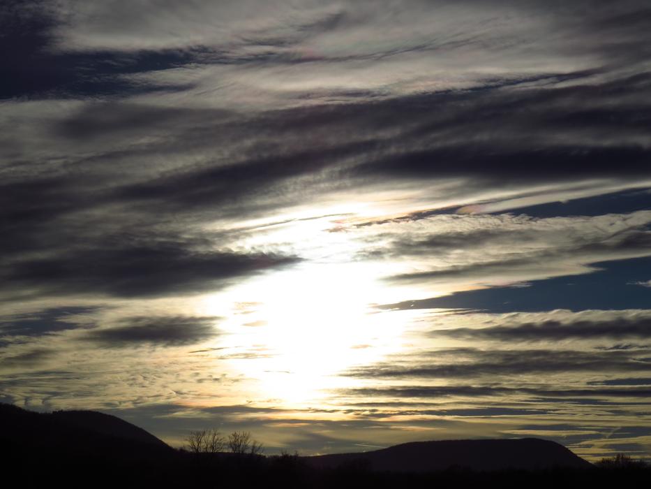 the sun illuminates the clouds
