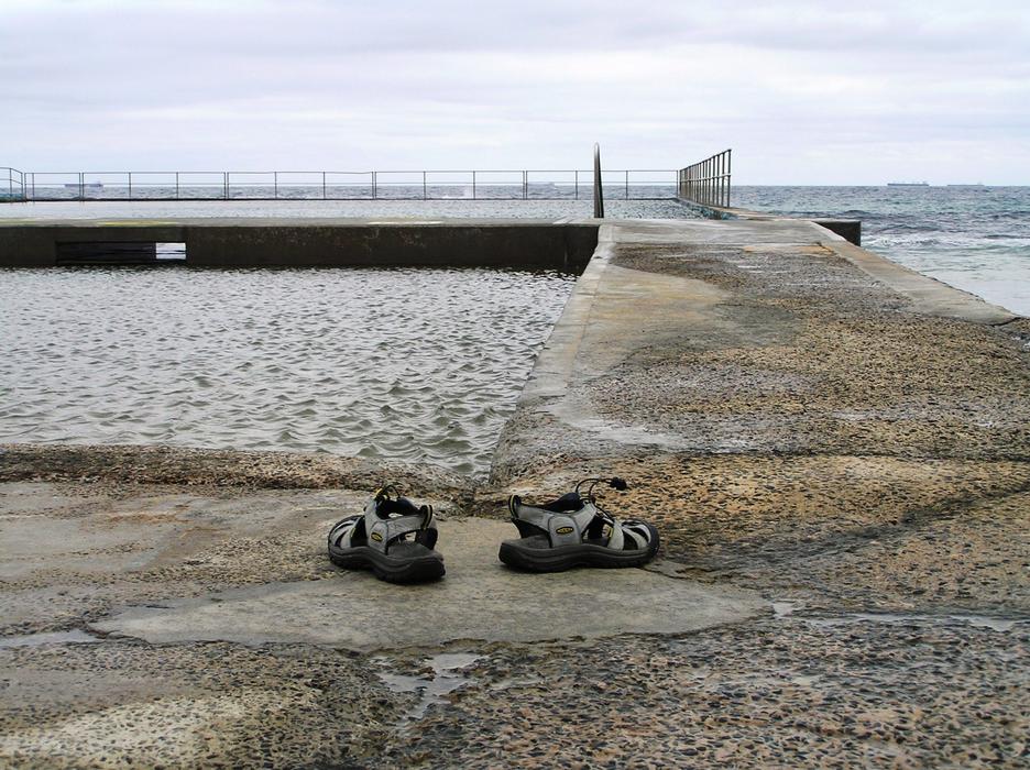 shoes near the stone bridge by the sea