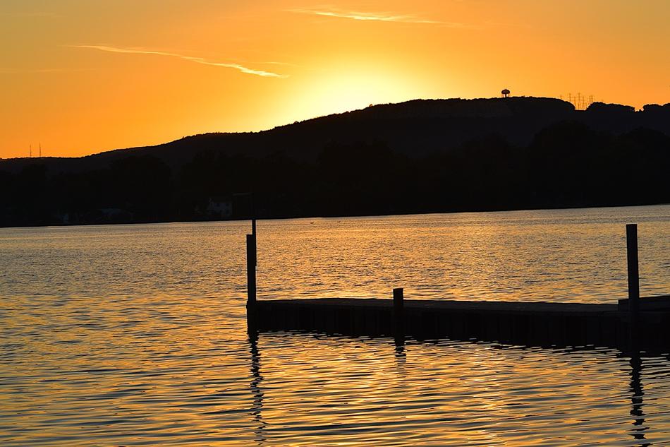 the silhouette of a black mountain with the sea