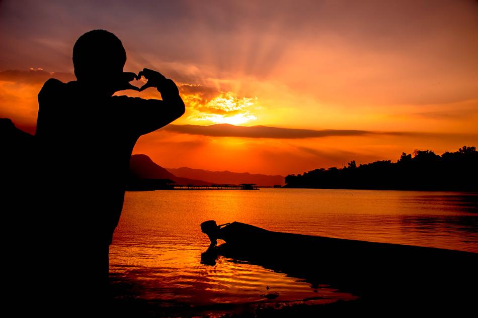 the silhouette of a man at sunset