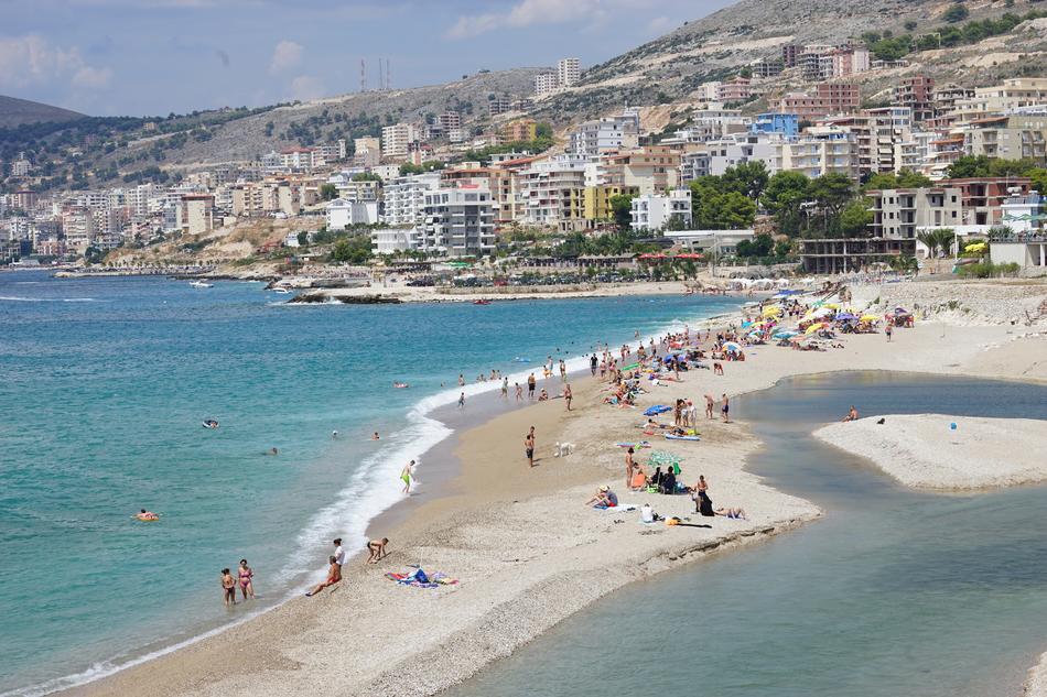 people vacationing by the beach with the sea