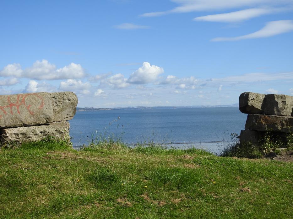 green grass with a stone wall
