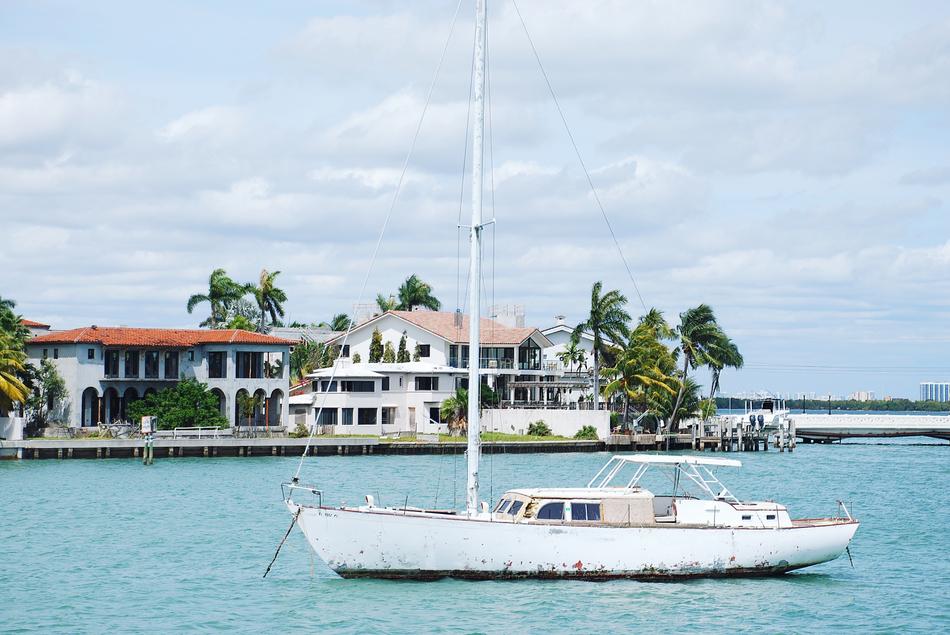 a white boat off a city on the ocean