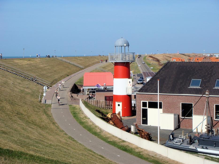 red lighthouse by the house