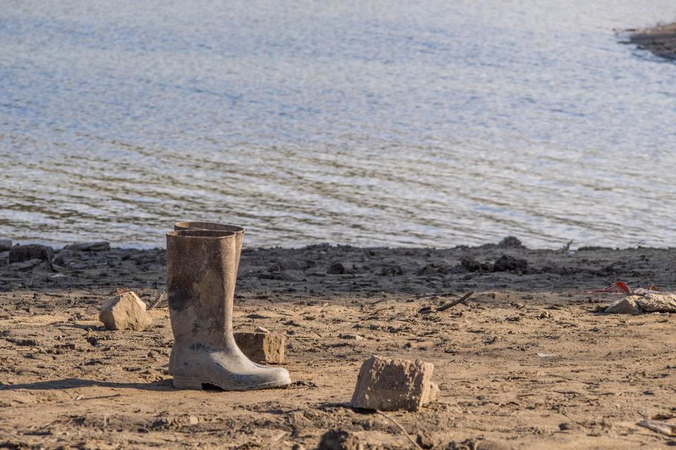 muddy boots on a sandy beach
