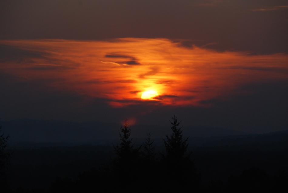 The setting sun into darkness