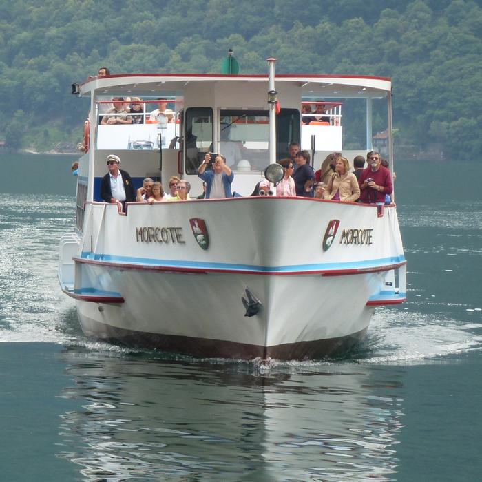 a white yacht with people on the way