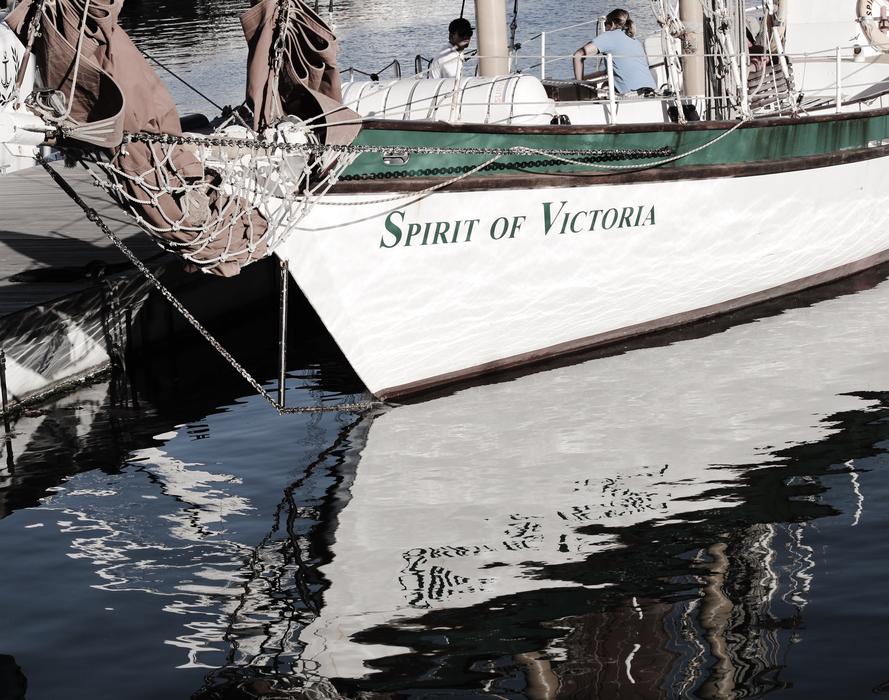 a white boat with writing on the sea