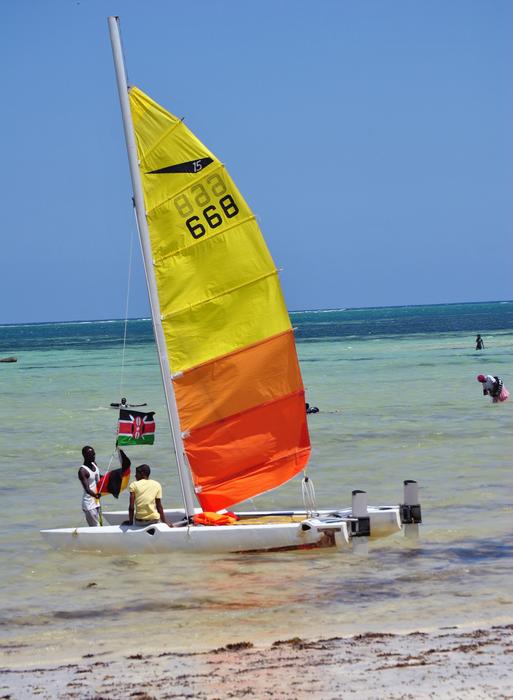 man next to a colored sail