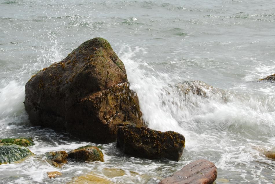 a large rock in a calm sea