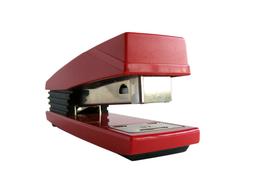 red stapler on a white background