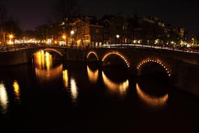 night illumination of an old stone bridge in Amsterdam