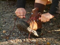 person lacing hiking Shoe