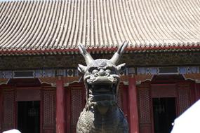 statue of a mythical creature in front of the temple