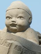 sand sculpture of a child on the shores of Lake Constance
