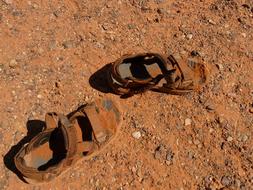 old dirty shoes in red sand