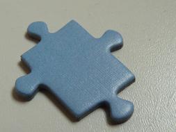 blue Puzzle Piece on grey surface