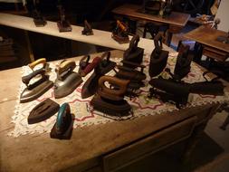 vintage irons on a table in a farm museum