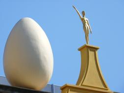 Big white egg on the roof of the beautiful Dali Museum at blue sky background in Spain