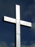 metal cross against a deep blue sky
