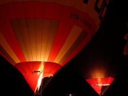 two red hot air balloons in the night sky