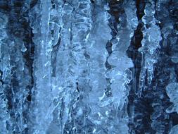 dark macro photo of icicles