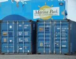 two blue shipping Containers at Wall