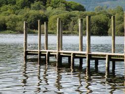 wooden pier with pillars on the lake