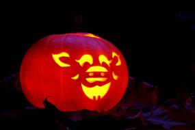 photo of a glowing pumpkin in the dark