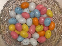 Beautiful and colorful, shiny sugar Easter eggs in the wicker basket