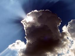 sunbeams bursting through scenic tall clouds