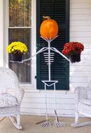 pumpkin and flowers on a stand as a skeleton