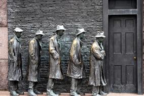 sculptures of hungry poor people