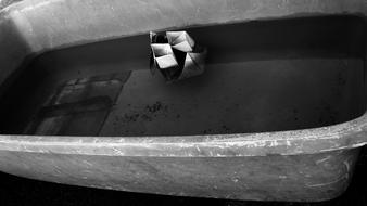 paper boat in an old bath