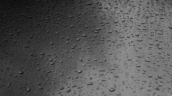 raindrops on a dark gray surface