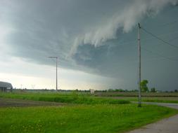 photo of a green lawn on the background of a stormy sky