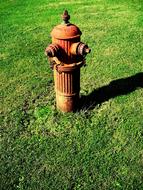 old fire hydrant on a green lawn