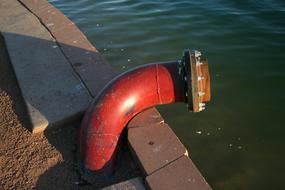 Red pipe near the lake