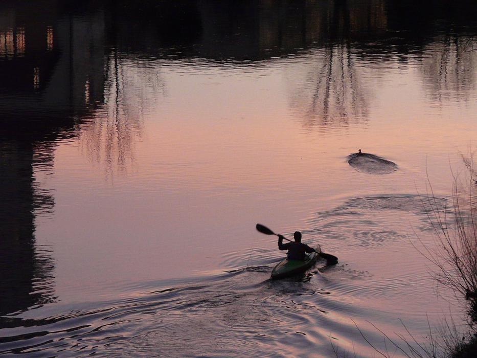 kayaker with paddles on the river