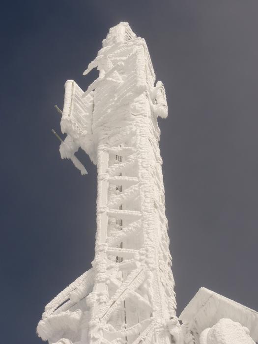 Beautiful ice tower at blue sky background in winter