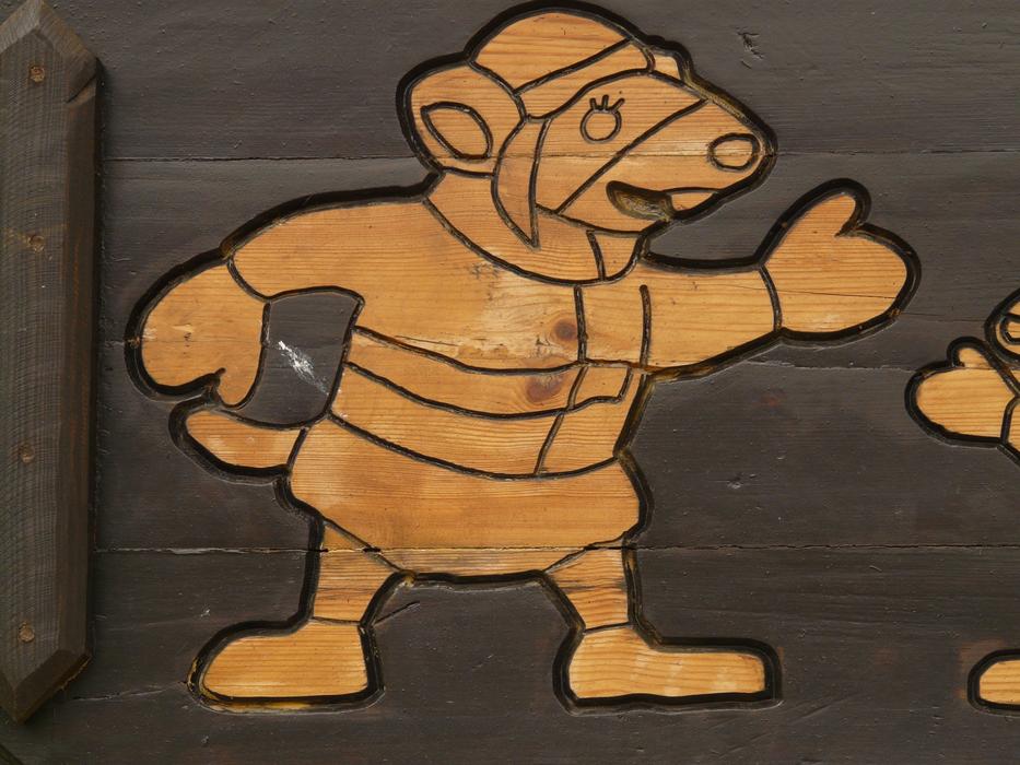 carved cartoon mouse on wood