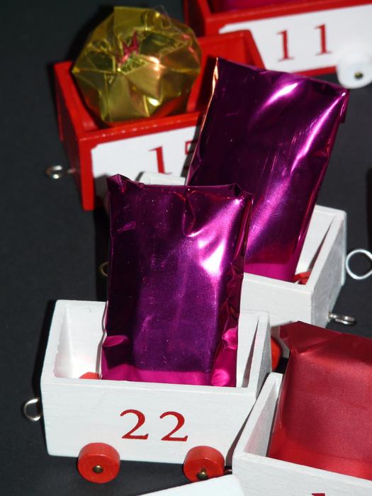Beautiful advent calendar with colorful gifts in the wagons
