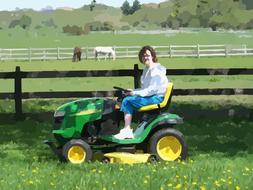 woman riding mini tractor on farm